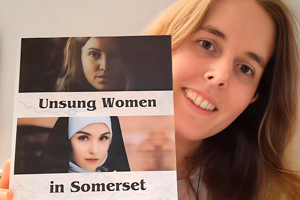 image of author Helen Pugh holding a copy of her book cover unsung women of Somerset